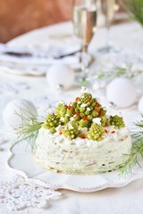 Obraz na płótnie Canvas crep cake for Christmas and New Year. Christmas tree decorations cabbage romanesco. Snack cake with salmon, avocado and soft cheese. Grains of cottage cheese play the role of snowdrifts.