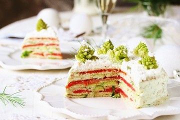 crep cake for Christmas and New Year.  Christmas tree decorations cabbage romanesco. Snack cake with salmon, avocado and soft cheese. Grains of cottage cheese play the role of snowdrifts.