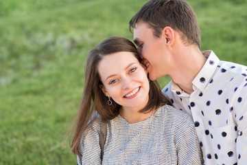 Loving man and woman having sweet tender moment together, happy millennial couple smile caressing each other, young husband and wife enjoy tenderness in summer day.
