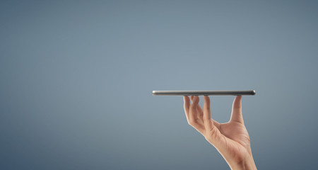 Hands holding a tablet touch computer gadget with isolated screen