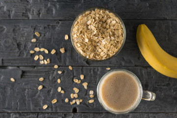 Oatmeal, banana and banana smoothie on wooden table. Flat lay.
