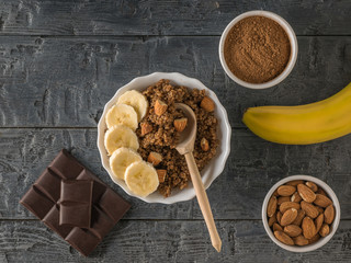 Quinoa porridge with banana and almond milk on a wooden table. Flat lay.