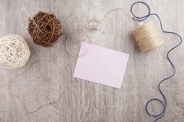 Fototapeta na wymiar twine and two decorative balls, burlap and coffee mug on light gray wooden background. Space for text