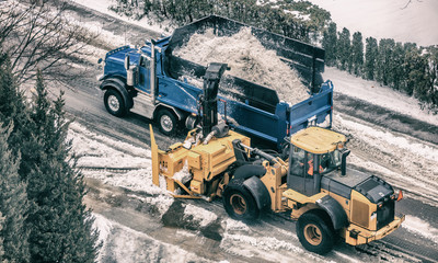 Snow removal plow truck cleaning city street removing snow with snowplow snowblower heavy duty...