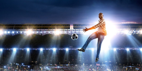 Soccer man in action with ball. Mixed media