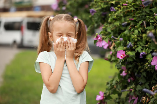 Little girl suffering from allergy outdoors