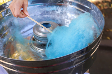 Fototapeta premium Making of sweet cotton candy outdoors, closeup