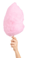Female hand with tasty cotton candy on white background