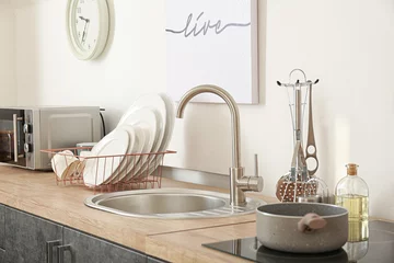 Fotobehang Set of clean dishware near kitchen sink © Pixel-Shot