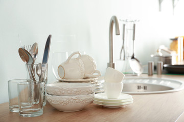 Set of clean dishware near kitchen sink