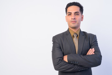 Portrait of handsome Persian businessman in suit with arms crossed