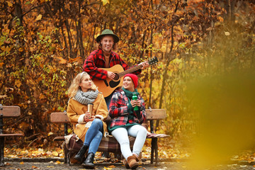 Friends resting in autumn park