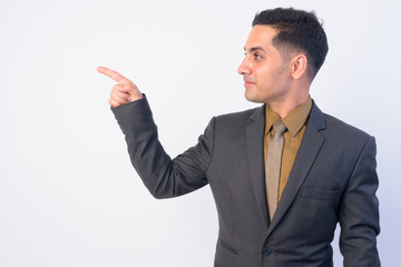 Profile view of handsome Persian businessman in suit pointing finger