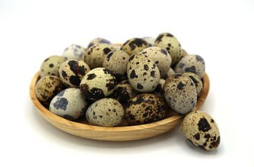 fresh eggs quail in Wooden plate on white background