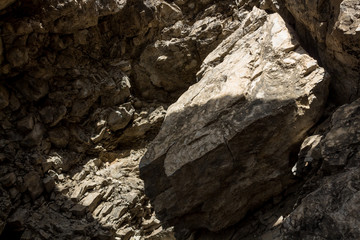 Beautiful sunlight falling in a deep rocky cave with unique textured stones. New beginning concept