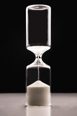 Hourglass on a dark background. Time is money. Business solutions in time.
