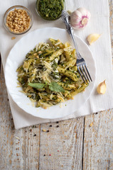  Penne Pasta with Pesto Sauce  on White Plate with Fork