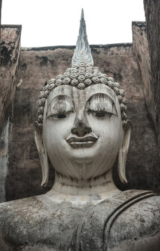 The ancient Phra Ajana Buddha image statue at Srichum temple in the old historical park in Sukhothai province , Thailand.