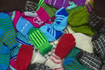 Fototapeta na wymiar Background from wool products. Socks, mittens.