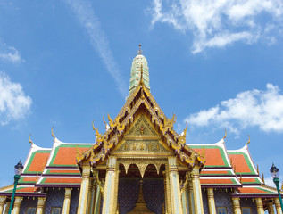 Traditional Thai architecture building in Grand Palace Bangkok with blue sky background.