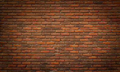 Abstract dark brown bricks stone wall with soft lighting and shadow for text or copy space background. Grunge and vintage black wallpaper design concept.