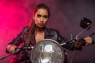 Fototapeta na wymiar girl on a motorcycle on fire