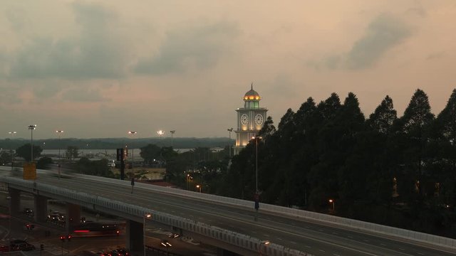 Slow Zoom in to Majlis Bandaraya Johor Bahru Clocktower in Malaysia in the evening. Cars travelling on highway.