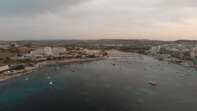 Aerial drone video from Malta, showing Qawra and Bugibba towns at sunset. MMXIX.VI.XI.