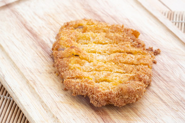 Japanese food, deep fried porkchop Tonkatsu on chopping wood.