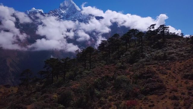 Aerial: Flight in Khumbu valley near Thamserku mount on the way to Everest bae camp