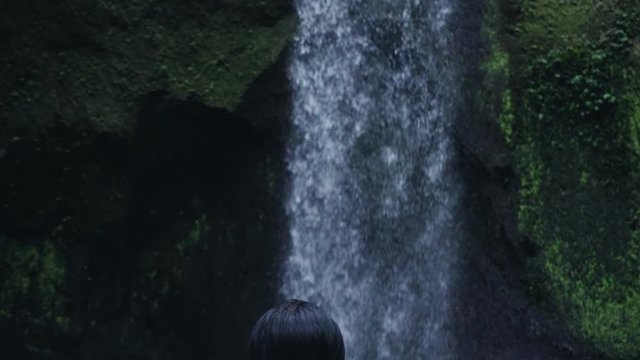 Asian female model at the wild forest waterfall