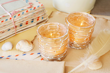 Golden candle holders, vintage letters and shells.