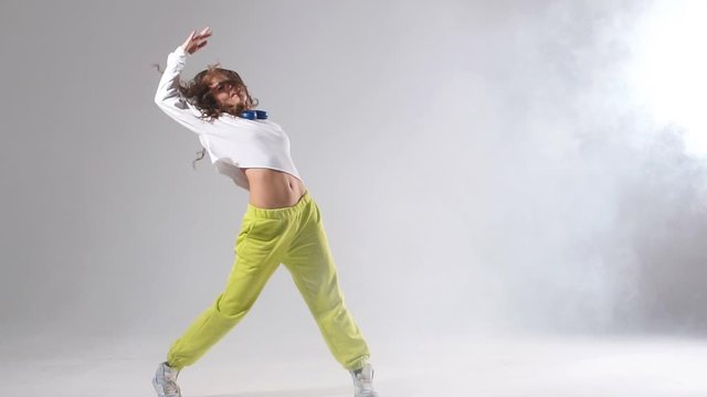 Charming young professional dance training hard before streetdance competition, spending free time at dance studio, preparing for concert