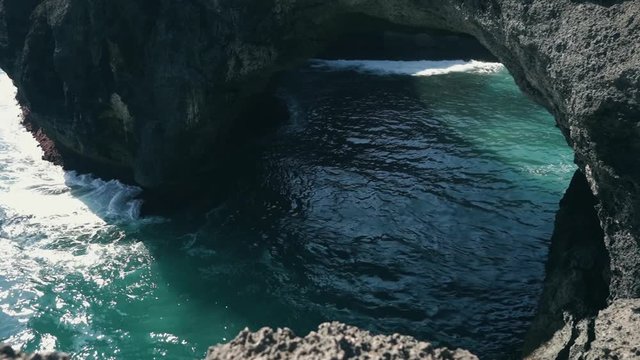 Ocean view to the Devill eye coast formation with blue lazure ocean water. Bali Indonesia