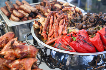 Meat and vegetables on a silver tray.