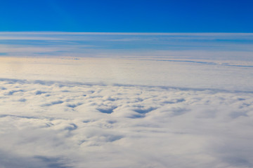 Fototapeta na wymiar Beautiful white clouds in blue sky. View from airplane