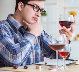 Professional sommelier tasting red wine
