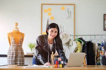 Cropped shot view of Fashion Designer stylish showroom working as fashion and drawing sketches for clothes in atelier.