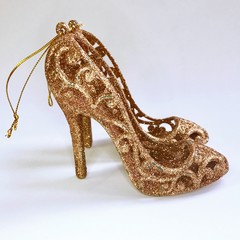 Christmas decoration - golden slipper. Shoe Cinderella. Gold princess shoes on a white background.