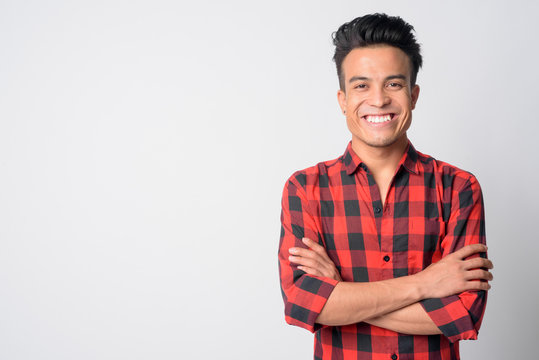 Portrait Of Happy Young Asian Hipster Man Smiling With Arms Crossed