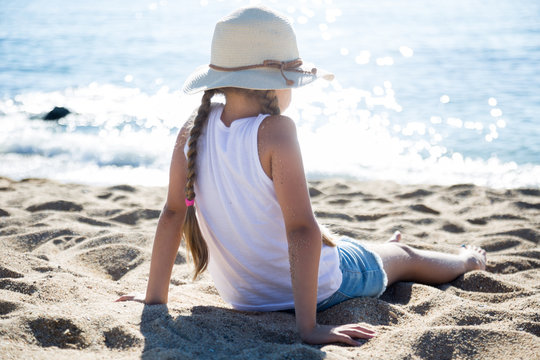 child in ha enjoying on sandy beach of sea coast