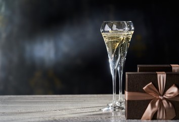 Gift boxes and two glasses of champagne. Copyspace for text.