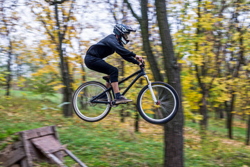 Fototapeta na wymiar Extreme cycling concept: mountain bike rider makes a jump.