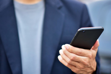 Businessman holding cell phone using Mobile phone or Smart phone Telephone to call phone with Social media Icon technology by WiFi internet  Network digital