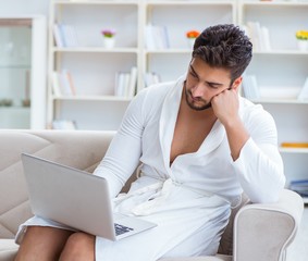 Young man freelancer working from home on a laptop