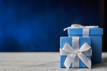 Blue gift box on white wooden table.