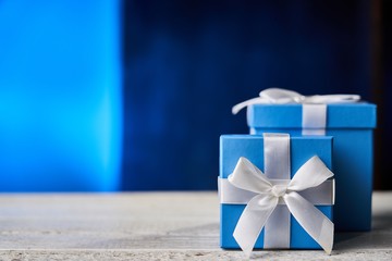 Blue gift box on white wooden table.