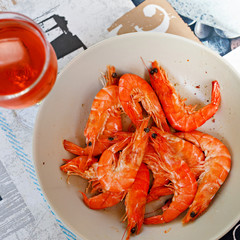 Shrimp salad and glass of rose wine in outdoor cafe in Spain