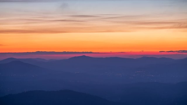 Sunrise seen from Beskids mountains with clouds flying around us.