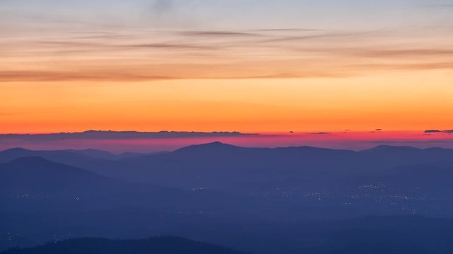 Sunrise seen from Beskids mountains with clouds flying around us.  Video with camera motion.